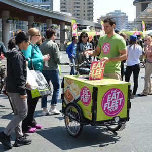 The Eat Fleet Tour OOH sampling goods out of a marketing Icicle Tricycles Ice Cream Bike Sampling Cart on the Canadian National Tour in Vancouver British Columbia